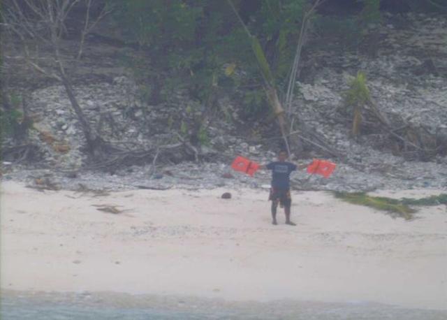 One of the men trying to catch the attention of a US Navy plane. (Photo: Twitter account of US Navy)