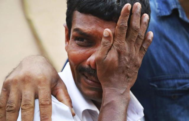 A man weeps as bodies of victims lie outside a morgue at the Kollam district hospital. (AP Photo) A man weeps as bodies of victims lie outside a morgue at the Kollam district hospital. (AP Photo)
