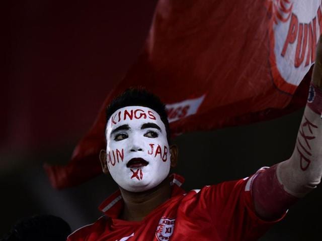 A supporter of the Kings XI Punjab waits for the start of the 2016 Indian Premier League (IPL) Twenty20 cricket match between Gujarat Lions and Kings XI Punjab. (AFP Photo) 