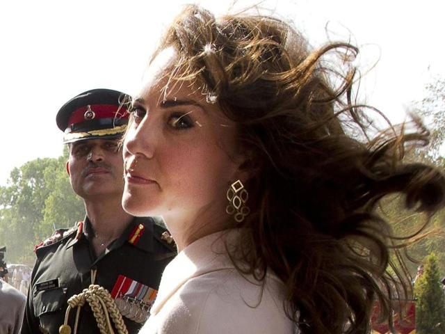 Britain's Prince William and his wife Catherine, Duchess of Cambridge, leave after paying their tributes at the India Gate war memorial.(REUTERS)