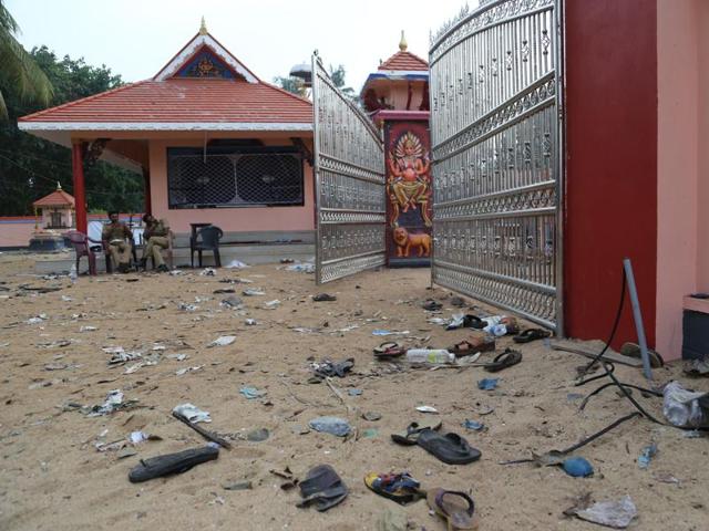 Footwear of the devotees lie scattered inside the temple compound where a massive fire broke out during a fireworks display at the Puttingal temple complex in Paravur village. (AP) Footwear of the devotees lie scattered inside the temple compound where a massive fire broke out during a fireworks display at the Puttingal temple complex in Paravur village. (AP)