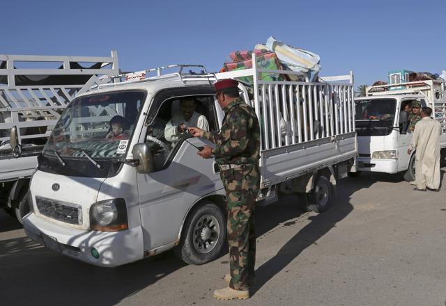 Iraqi security forces check identification documents at a checkpoint near the entrance to Ramadi, 70 miles (115 km) west of Baghdad, Iraq, Sunday, April 3, 2016. Thousands of civilians have returned to the city after Iraqi government forces retook the Anbar provincial capital from the Islamic State group earlier this year. (AP)