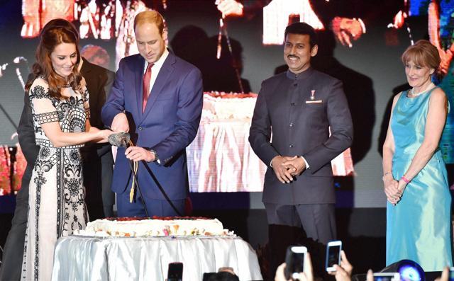 The Royal couple cutting a cake with a sword. (PTI) The Royal couple cutting a cake with a sword. (PTI)