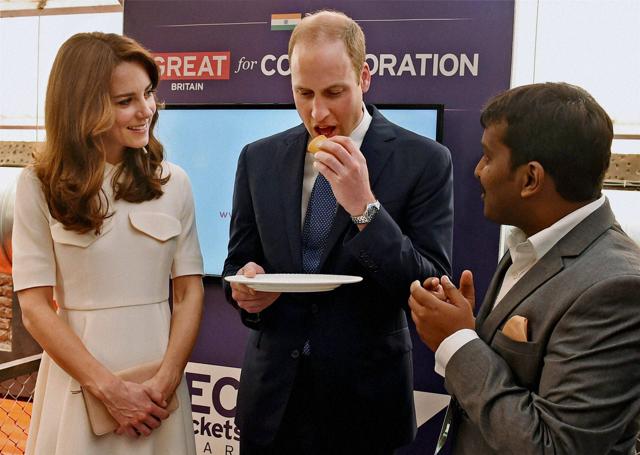 Prince William eats a dosa as Catherine looks on. (PTI) Prince William eats a dosa as Catherine looks on. (PTI)
