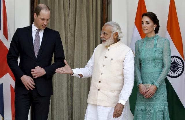 Britain's Prince William shakes hands with Prime Minister Narendra Modi as Catherine, Duchess of Cambridge, smiles during a photo opportunity at Hyderabad House. (REUTERS) Britain's Prince William shakes hands with Prime Minister Narendra Modi as Catherine, Duchess of Cambridge, smiles during a photo opportunity at Hyderabad House. (REUTERS)