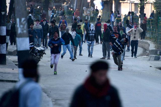 Protesters throw stones at the police during clashes in Srinagar on April 12.(PTI)