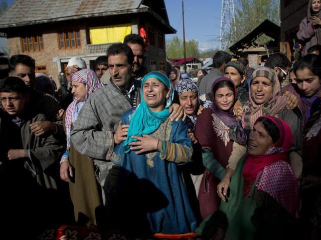 Relatives of Raja Begum wail as her body arrives at her residence in Langate.  (AP) 