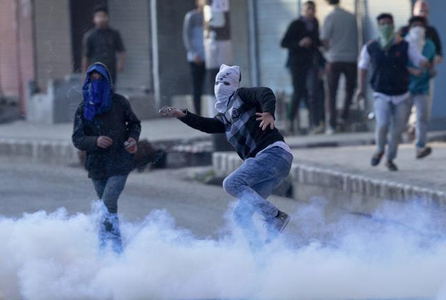 A masked protester throws rocks and bricks at security personnel during a protest in Srinagar. (AP Photo) A masked protester throws rocks and bricks at security personnel during a protest in Srinagar. (AP Photo)