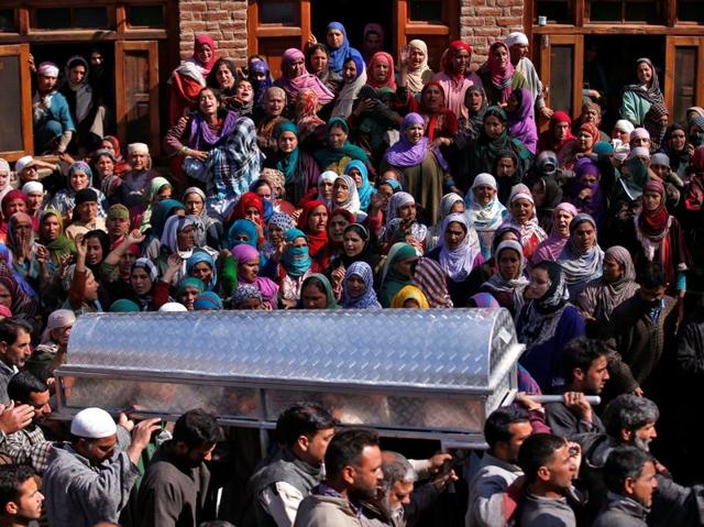 Kashmiri Muslim men carry a coffin containing the body of Raja Begum during her funeral in Langate, north of Srinagar on Wednesday. (Reuters) 