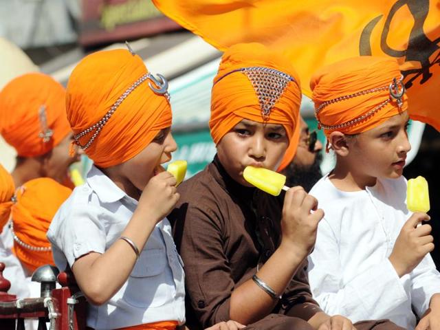 Children enjoying ice cream during the Nagar Kirtan in Patiala on Wednesday. (Bharat Bhushan/HT)