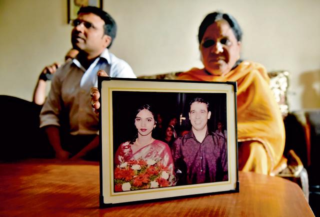Pamela and her son Ashish Wilson with a photo of Rajeev and his wife. The family says nothing can fill the void left by Rajeev’s death. (Vipin Kumar/HT Photo)