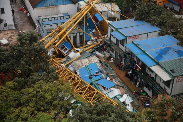 Rescuers work at the accident site of a collapsed temporary structure. (AFP)