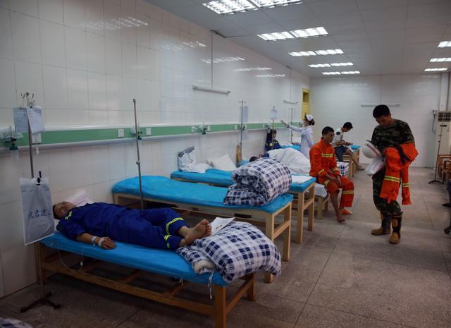 Rescuers and workers who were wounded in a crane collapse accident, receive medical treatment at a hospital in Dongguan, south China's Guangdong Province. (AFP)