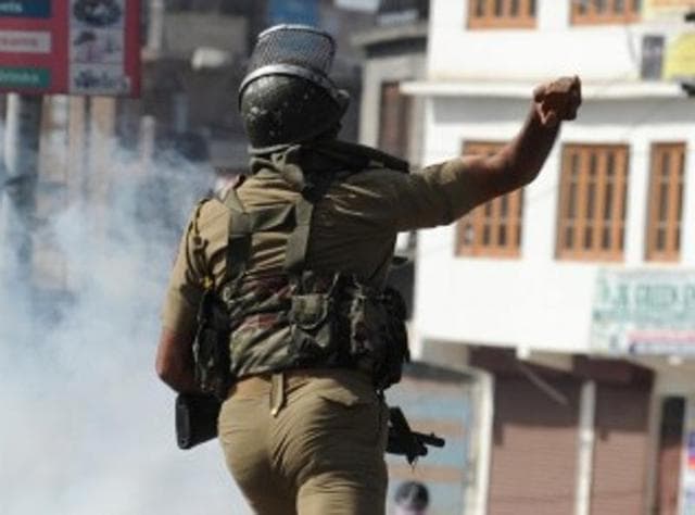 An Indian security personnel throws a rock towards Kashmiri protestors during clashes in Srinagar on April 17, 2015. (AFP) An Indian security personnel throws a rock towards Kashmiri protestors during clashes in Srinagar on April 17, 2015. (AFP)
