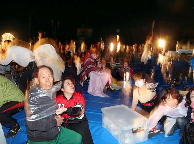 Residents take shelter at the town hall of Mashiki, in Kumamoto, southern Japan, after an earthquake Thursday, April 14, 2016. A powerful earthquake with a magnitude of 6.5 knocked over buildings in southern Japan on Thursday evening, and police said people may be trapped underneath. (AP Photo) Residents take shelter at the town hall of Mashiki, in Kumamoto, southern Japan, after an earthquake Thursday, April 14, 2016. A powerful earthquake with a magnitude of 6.5 knocked over buildings in southern Japan on Thursday evening, and police said people may be trapped underneath. (AP Photo)