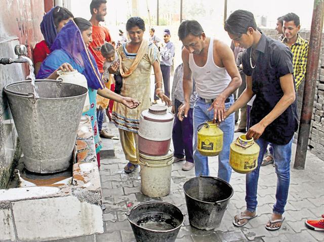 Locals filling buckets of water from a private water tank outside Satsang Bhawan at Preet Nagar in Ludhiana on Wednesday.(JS Grewal/HT) Locals filling buckets of water from a private water tank outside Satsang Bhawan at Preet Nagar in Ludhiana on Wednesday.(JS Grewal/HT)