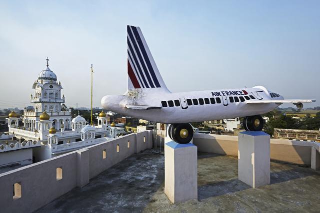Over a period of 15 years, three brothers migrated to Paris from village Khaira Majja in Jalandhar to work as electricians. They put up this airplane-shaped water tank atop their house to display the flag of France and the name of the carrier. (Rajesh Vora/PHOTOINK) Over a period of 15 years, three brothers migrated to Paris from village Khaira Majja in Jalandhar to work as electricians. They put up this airplane-shaped water tank atop their house to display the flag of France and the name of the carrier. (Rajesh Vora/PHOTOINK)