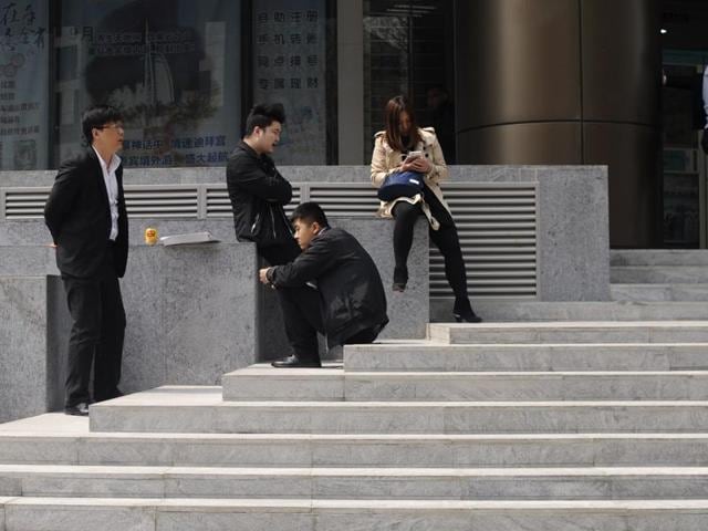 A group of car-cleaners wait for customers at a central business district in Beijing. China's growth slowed further in the first three months of this year. (AFP) A group of car-cleaners wait for customers at a central business district in Beijing. China's growth slowed further in the first three months of this year. (AFP)