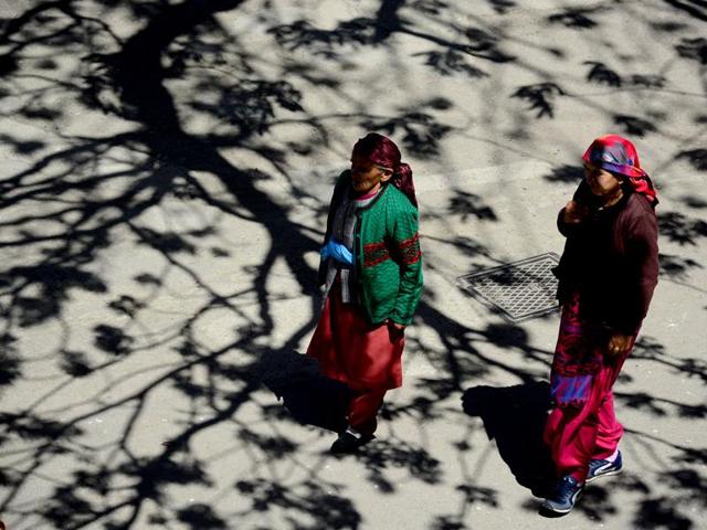 Two women are seen walking on a hot afternoon in Shimla. Significant relief from hot weather conditions is highly unlikely in the coming days, weather forecaster Skymet has said. (Deepak Sansta/HT photo)