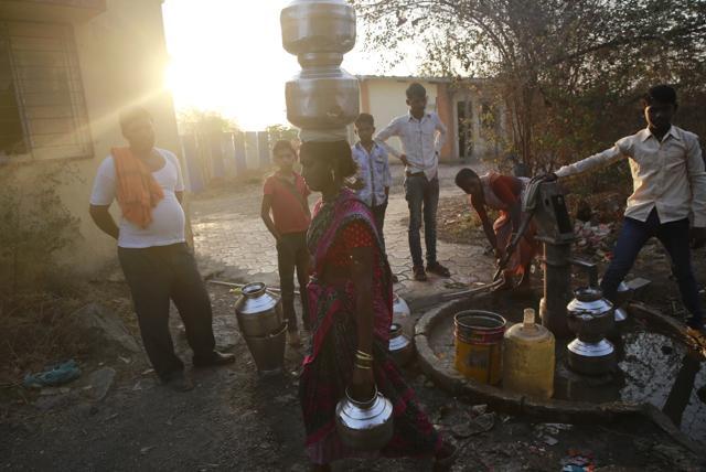 In this April 12, 2016 photo, a woman leaves after filling her vessels with water at a communal tap in Kukse Borivali, 85 kilometers (53 miles) north-east of Mumbai. (AP) In this April 12, 2016 photo, a woman leaves after filling her vessels with water at a communal tap in Kukse Borivali, 85 kilometers (53 miles) north-east of Mumbai. (AP)