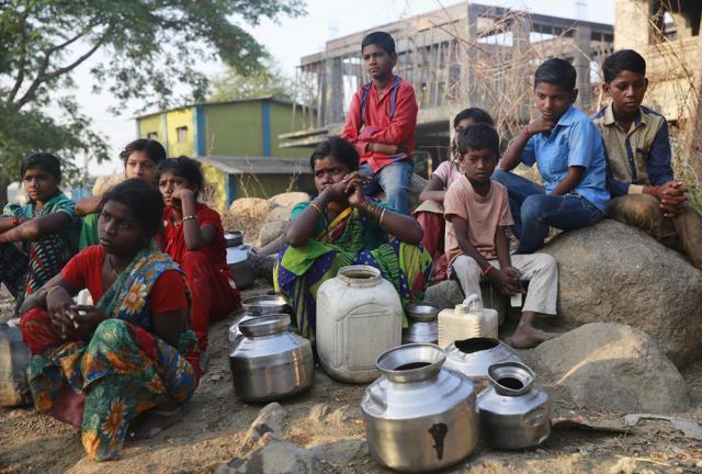 People waiting to fill their vessels with water at a communal tap in Kukse Borivali, 85 kilometers (53 miles) north-east of Mumbai, India. (AP) People waiting to fill their vessels with water at a communal tap in Kukse Borivali, 85 kilometers (53 miles) north-east of Mumbai, India. (AP)