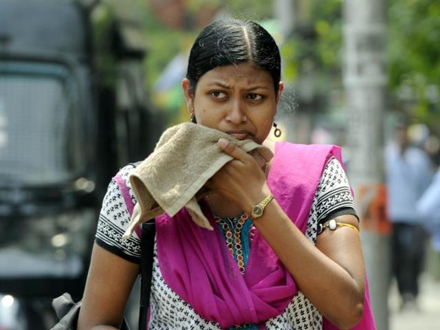 A woman wipes her face on a hot afternoon in Kolkata. Temperatures have risen unusually in the first week of April with several parts of the country recording deviations of more than +5°C. (Ashok Nath Dey/HT photo)