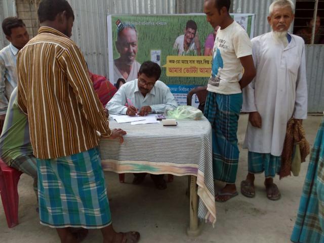 Residents of former Bangladeshi enclave in Cooch Behar, West Bengal, who became Indian citizens in November last year, get their photo voter ID cards on April 15, 2015. (HT Photo )