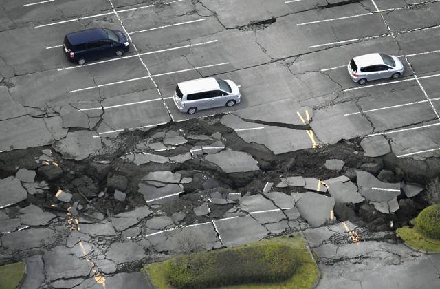 Vehicles sit at a parking lot damaged by an earthquake at Minamiaso in Kumamoto prefecture. (AP)