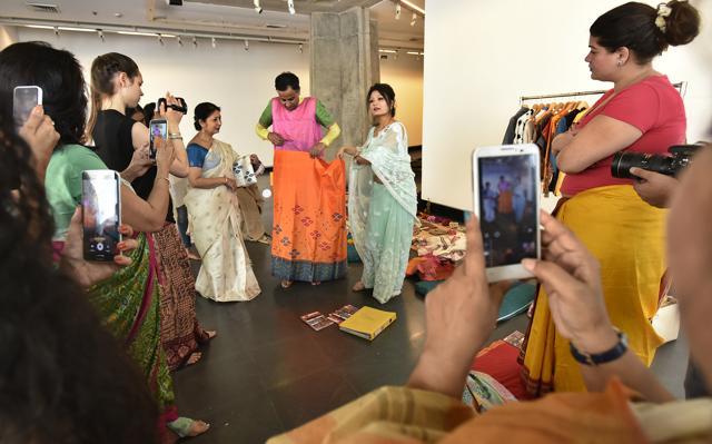 Arts curator Himanshu Verma and Assamese fashion designer Pranami Kalita demonstrate how to tie the Mekhela Chador, which is a two-piece garment. (Raj K Raj/HT) Arts curator Himanshu Verma and Assamese fashion designer Pranami Kalita demonstrate how to tie the Mekhela Chador, which is a two-piece garment. (Raj K Raj/HT)