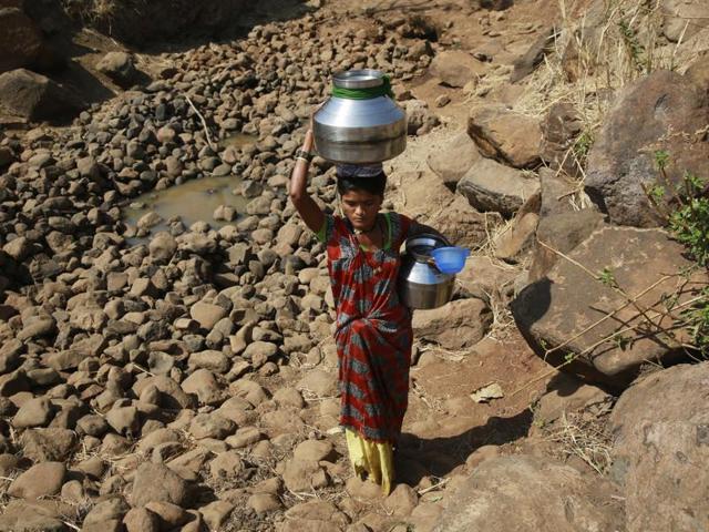 In this April 12, 2016 photo, a woman along with her son walks to get water from a communal tube well at Raichi Wadi village, 120 kilometers (75 miles) north-east of Mumbai, India. Decades of groundwater abuse, populist water policies and poor monsoons have turned vast swathes of central and western India into a dust bowl. (AP Photo) In this April 12, 2016 photo, a woman along with her son walks to get water from a communal tube well at Raichi Wadi village, 120 kilometers (75 miles) north-east of Mumbai, India. Decades of groundwater abuse, populist water policies and poor monsoons have turned vast swathes of central and western India into a dust bowl. (AP Photo)