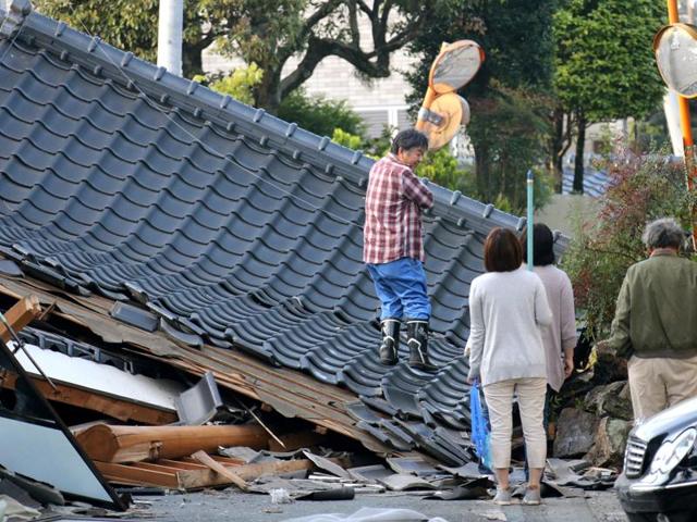 Police officers conduct a search operation at the site of a landslide caused by an earthquake in Minamiaso village, Kumamoto prefecture, Japan, Saturday. The powerful earthquake struck southwestern Japan early Saturday, barely 24 hours after a smaller quake hit the same region. (AP) Police officers conduct a search operation at the site of a landslide caused by an earthquake in Minamiaso village, Kumamoto prefecture, Japan, Saturday. The powerful earthquake struck southwestern Japan early Saturday, barely 24 hours after a smaller quake hit the same region. (AP)