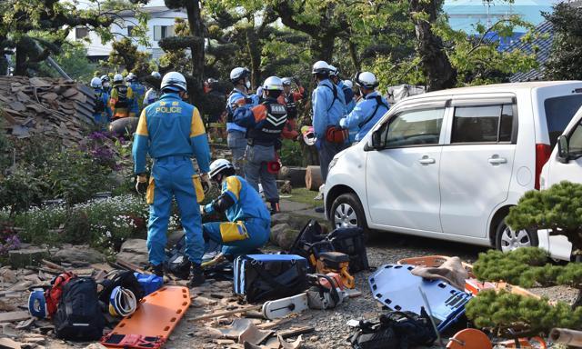 Policemen prepare for a rescue mission in Mashiki, Kumamoto prefecture. Japanese media reported that nearly 200,000 homes were without electricity. Drinking water systems had also failed in the area. TV footage showed people huddled quietly in blankets, shoulder to shoulder, on floors of evacuation centres. (AFP) Policemen prepare for a rescue mission in Mashiki, Kumamoto prefecture. Japanese media reported that nearly 200,000 homes were without electricity. Drinking water systems had also failed in the area. TV footage showed people huddled quietly in blankets, shoulder to shoulder, on floors of evacuation centres. (AFP)