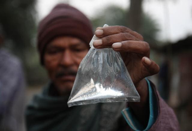 A villager shows a packet of illicit liquor , a 'hooch pouch' at Magrahat in West Bengal’s South 24 Parganas, on December 15, 2011. Around 170 people had died and hundreds fell ill after consuming spurious liquor. (Subhendu Ghosh / HT Photo) A villager shows a packet of illicit liquor , a 'hooch pouch' at Magrahat in West Bengal’s South 24 Parganas, on December 15, 2011. Around 170 people had died and hundreds fell ill after consuming spurious liquor. (Subhendu Ghosh / HT Photo)