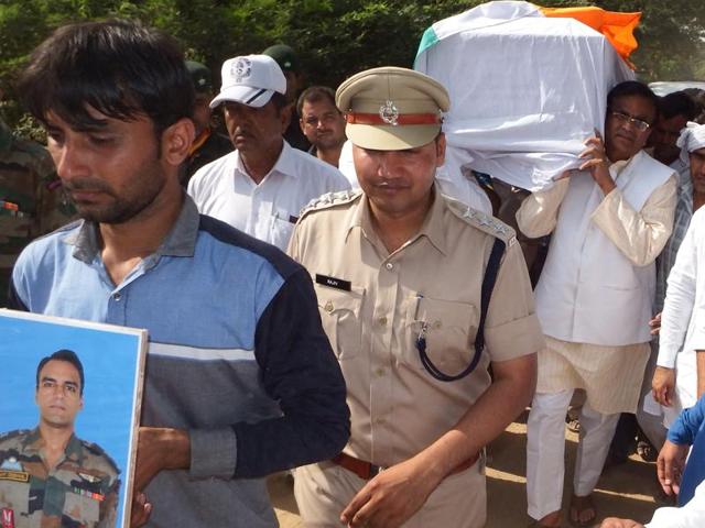 Haryana agriculture minister OP Dhankar among the pallbearers during the cremation of Major Amit Deswal at Surehti village in Jhajjar district on Friday.(Manoj Dhaka/HT Photo) Haryana agriculture minister OP Dhankar among the pallbearers during the cremation of Major Amit Deswal at Surehti village in Jhajjar district on Friday.(Manoj Dhaka/HT Photo)
