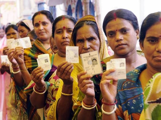 Women voters show their voter IDs while in queue at a polling booth in Bolpur of Birbhum district on Sunday. (Subhendu Ghosh/ HT Photo) Women voters show their voter IDs while in queue at a polling booth in Bolpur of Birbhum district on Sunday. (Subhendu Ghosh/ HT Photo)