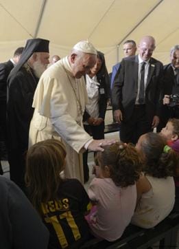 Pope Francis caresses a child as he meets migrants at the Moria camp on the Greek island of Lesbos. (AP) Pope Francis caresses a child as he meets migrants at the Moria camp on the Greek island of Lesbos. (AP)
