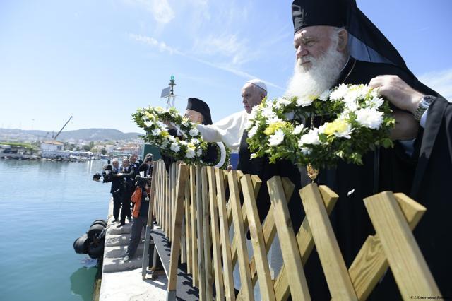 This handout picture released by the Vatican press office shows Pope Francis (C), Ecumenical Patriarch Bartholomew I, spiritual leader of the world’s Orthodox Christians (L) and Archbishop of Athens and All Greece Ieronymos II (R) throwing wreaths of flowers in the port of Mytilene in memory of the migrants who died at sea trying to reach Europe. (AFP) This handout picture released by the Vatican press office shows Pope Francis (C), Ecumenical Patriarch Bartholomew I, spiritual leader of the world’s Orthodox Christians (L) and Archbishop of Athens and All Greece Ieronymos II (R) throwing wreaths of flowers in the port of Mytilene in memory of the migrants who died at sea trying to reach Europe. (AFP)