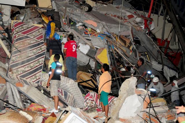 People stand on the debris of a building after an earthquake struck off the Pacific coast in Manta, Ecuador. (REUTERS) People stand on the debris of a building after an earthquake struck off the Pacific coast in Manta, Ecuador. (REUTERS)