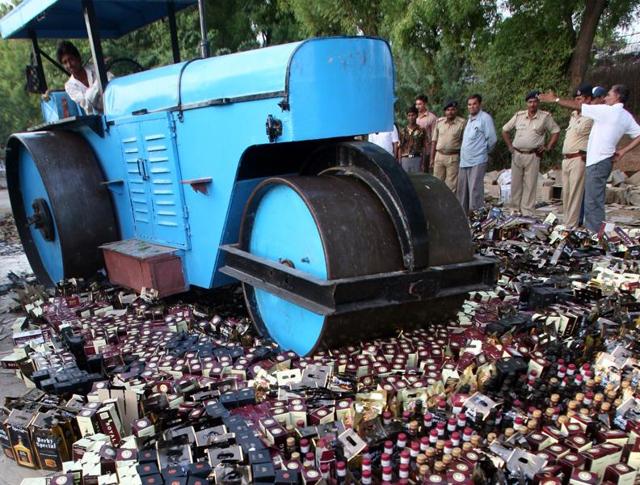 Seized liquor bottles being destroyed in Koba village, Gujarat, on May 26, 2007. Drinking and selling alcohol in Gujarat is prohibited(REUTERS)