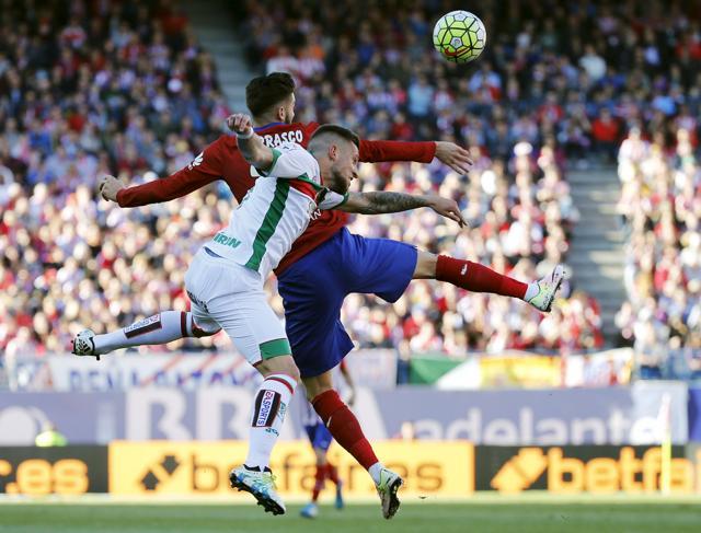 Atletico Madrid's Yannick Ferreira-Carrasco and Granada's Cristiano Biraghi in action. (Reuters Photo) Atletico Madrid's Yannick Ferreira-Carrasco and Granada's Cristiano Biraghi in action. (Reuters Photo)