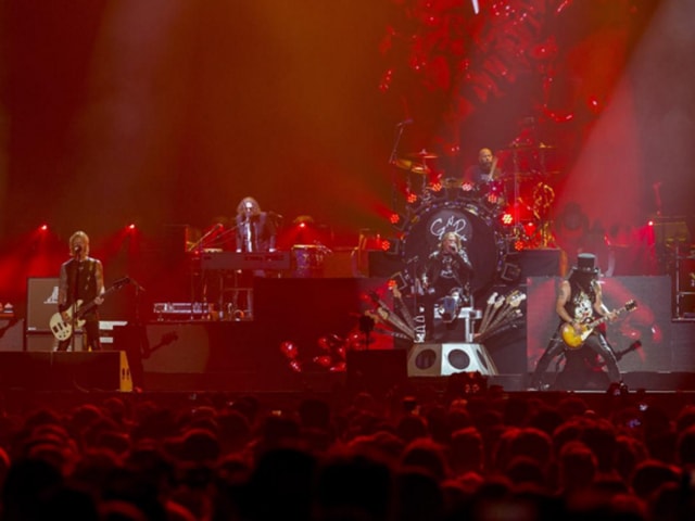 Guns N’ Roses perform at the Coachella music festival in California. Slash’s iconic headgear is visible in the darkness. (Instagram) 