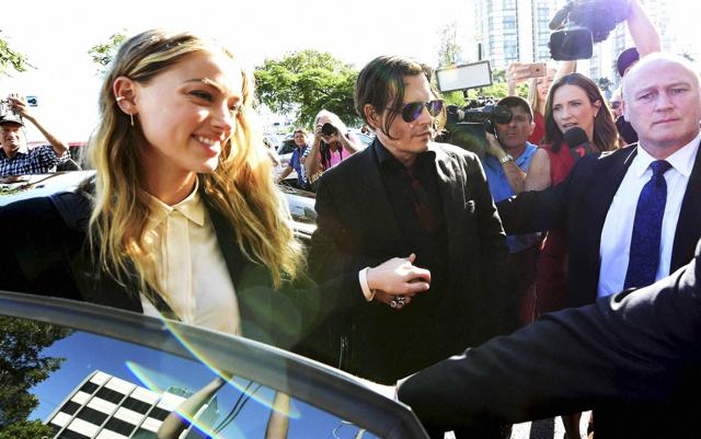 Brisbane : Johnny Depp, center, and wife Amber Heard, left, arrive at the Southport Magistrates Court on the Gold Coast, Australia, Monday, April 18, 2016. Heard pleaded guilty to providing a false immigration document amid allegations she smuggled the couple's dogs into Australia. AP/PTI(AP4_18_2016_000101B) (AP) Brisbane : Johnny Depp, center, and wife Amber Heard, left, arrive at the Southport Magistrates Court on the Gold Coast, Australia, Monday, April 18, 2016. Heard pleaded guilty to providing a false immigration document amid allegations she smuggled the couple's dogs into Australia. AP/PTI(AP4_18_2016_000101B) (AP)