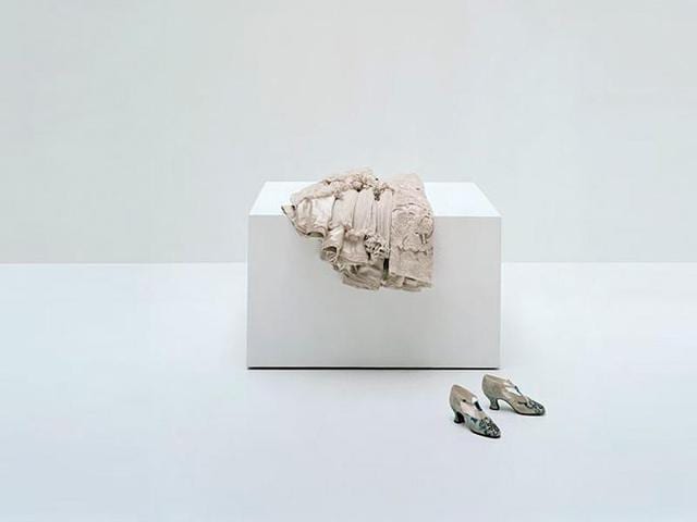 Redfern evening cape, circa 1900-1905, and Vaginay T-bar shoes, circa 1925, worn by Anna Gould (Countess Boni de Castellane, 1875-1961). Cape: champagne wool twill and champagne silk tulle with champagne silk embroidery. Shoes: cream damask silk with gold and blue silk embroidery, diamante . (AFP) Redfern evening cape, circa 1900-1905, and Vaginay T-bar shoes, circa 1925, worn by Anna Gould (Countess Boni de Castellane, 1875-1961). Cape: champagne wool twill and champagne silk tulle with champagne silk embroidery. Shoes: cream damask silk with gold and blue silk embroidery, diamante . (AFP)