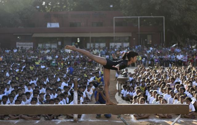 A student of Samarth Vyayam Mandir demonstrates her skill  to the students and parents during the opening ceremony of a summer camp at Dadar in Mumbai, India, on Sunday.  (Satish bate/Hindustan Times) 