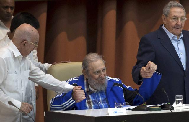 Fidel Castro sits as he clasps hands with his brother, Cuban President Raul Castro (R), and second secretary of the Central Committee, Jose Ramon Machado Ventura. (AP Photo) Fidel Castro sits as he clasps hands with his brother, Cuban President Raul Castro (R), and second secretary of the Central Committee, Jose Ramon Machado Ventura. (AP Photo)
