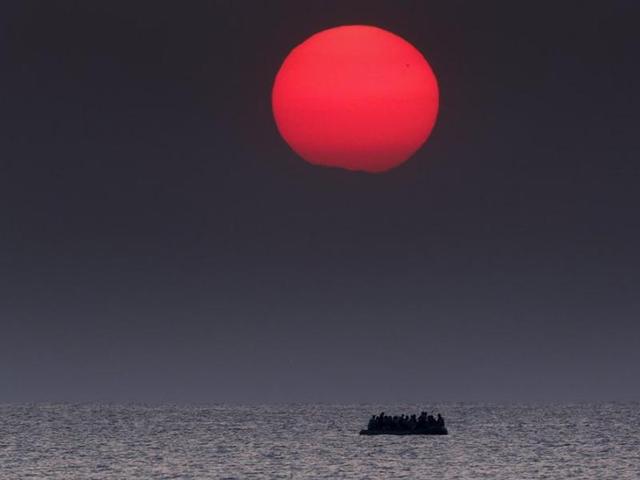 A overcrowded inflatable boat with Syrian refugees drifts in the Aegean sea between Turkey and Greece after its motor broke down off the Greek island of Kos, August 11, 2015. (Yannis Behrakis/REUTERS)