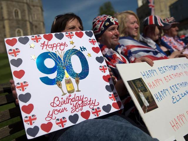 Royal well-wishers hold placards wishing Britain's Queen Elizabeth II a happy 90th birthday as they wait in hope of seeing her following her engagements in Windsor, west of London. (AFP Photo) Royal well-wishers hold placards wishing Britain's Queen Elizabeth II a happy 90th birthday as they wait in hope of seeing her following her engagements in Windsor, west of London. (AFP Photo)