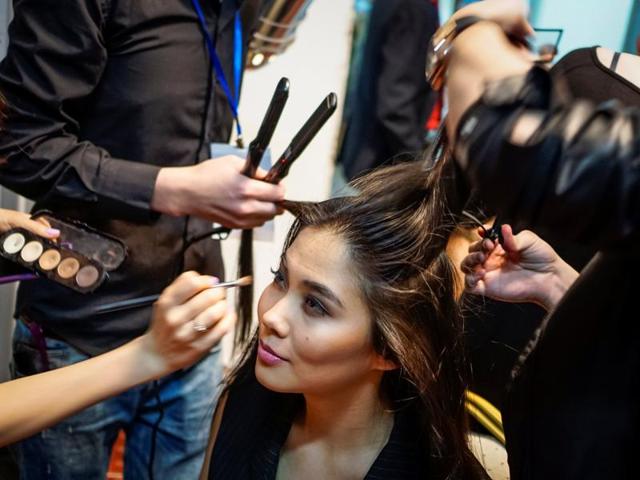 A model has her hair and make up done backstage. (REUTERS) A model has her hair and make up done backstage. (REUTERS)