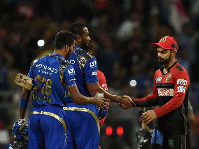 Hardik Pandya and Kieron Pollard being greeted by Royal Challengers Bangalore captain Virat Kohli after the win. (PTI) Hardik Pandya and Kieron Pollard being greeted by Royal Challengers Bangalore captain Virat Kohli after the win. (PTI)