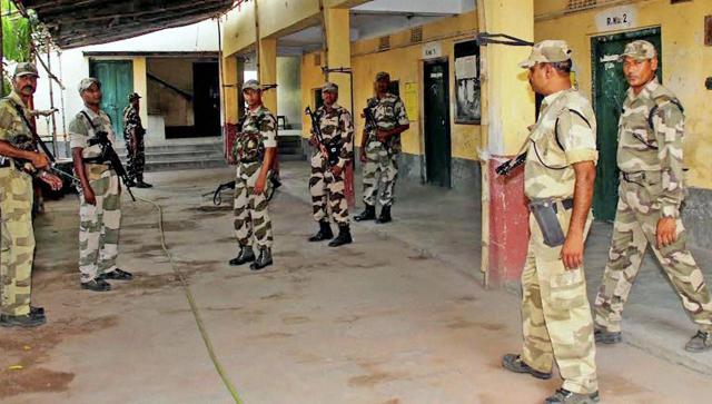Central Force Jawan stand guard inside a polling booth on the eve of 3rd phase of Assembly Polls in Burdwan district of West Bengal on Wednesday. (PTI) Central Force Jawan stand guard inside a polling booth on the eve of 3rd phase of Assembly Polls in Burdwan district of West Bengal on Wednesday. (PTI)
